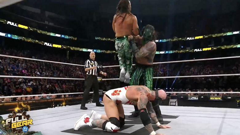 Luchasaurus about to chokeslam Matt on top of Alexander