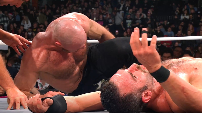 Jon Moxley and Roderick Strong struggle on the canvas