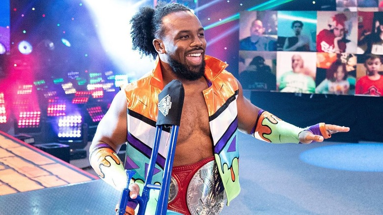 Austin Creed (formerly known as WWE star Xavier Woods) smiles on as he makes his way down towards the ring