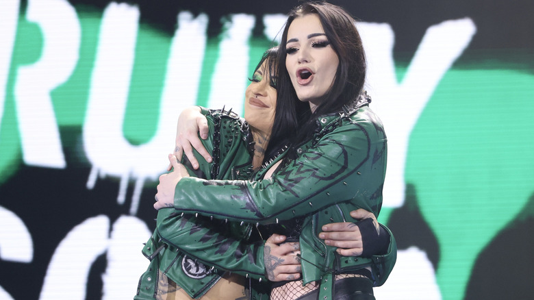 The Outcasts hugging