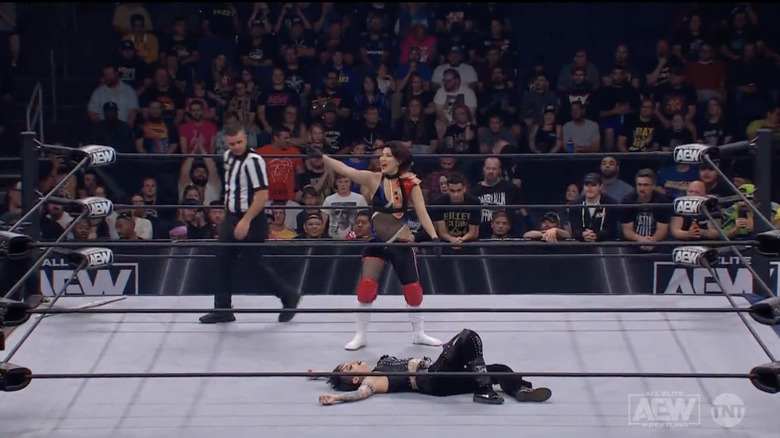 Shida standing over Soho