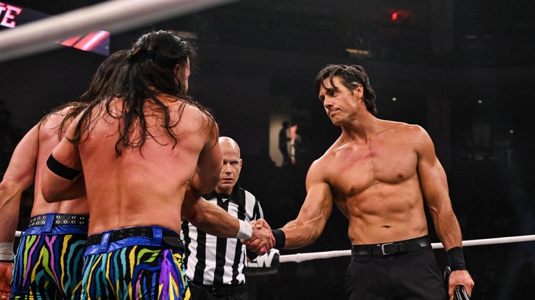 Steve Borden shakes The Young Bucks hands