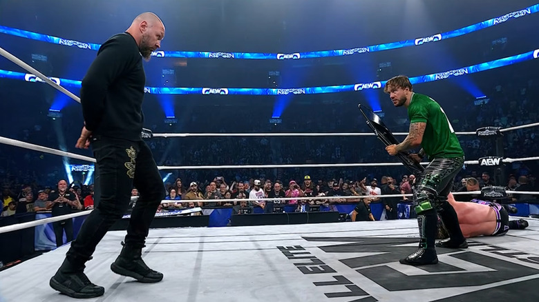 Will Ospreay wards off Jon Moxley with a steel chair