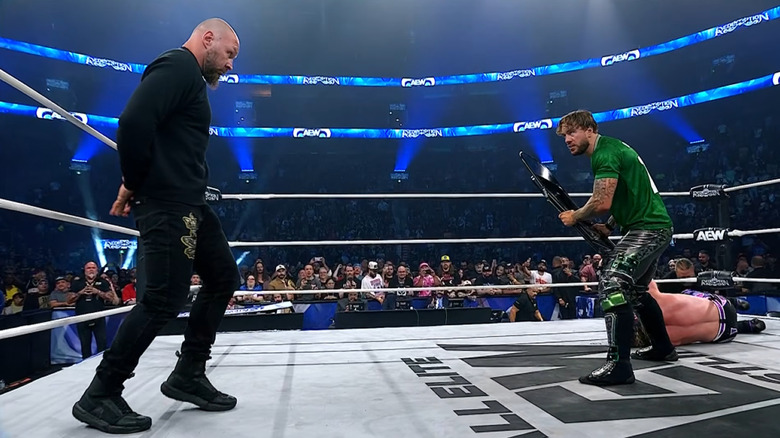Will Ospreay wards off Jon Moxley with a steel chair