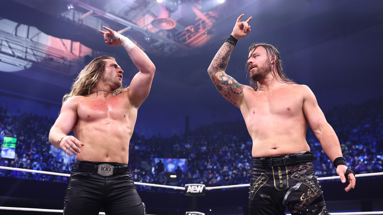 The Dogs' Clark Connors and David Finlay pose in the ring following a victory on an episode of AEW programming.