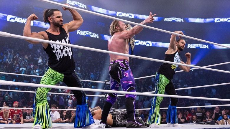 Kenny Omega poses with The Young Bucks at the end of AEW Redemption