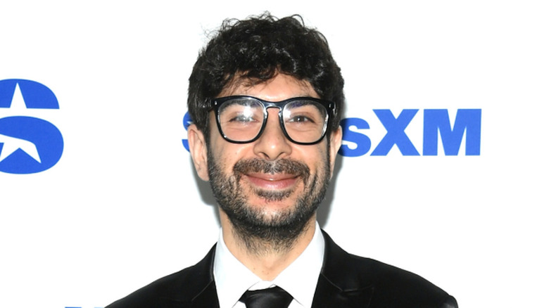 Tony Khan posing for yet another photo