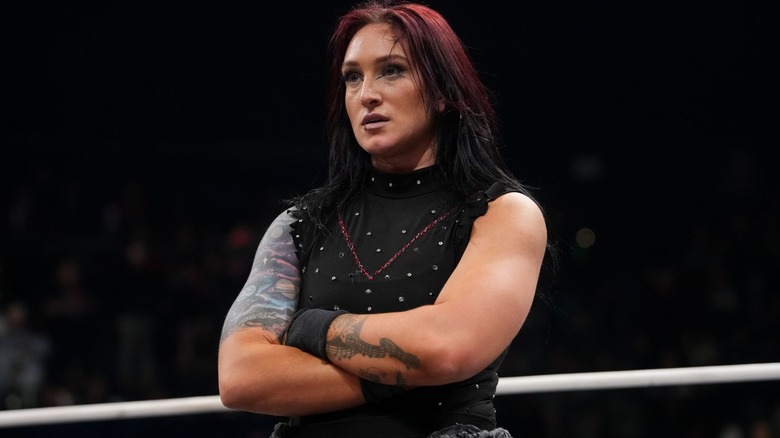 Kris Statlander standing with her arms folded