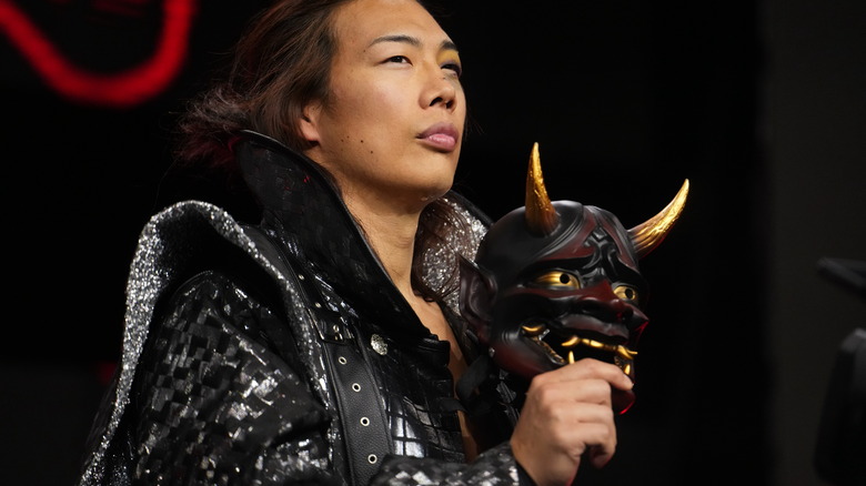 Konosuke Takeshita holding an oni mask