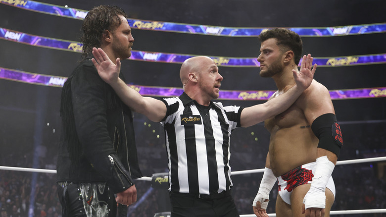 "Hangman" Adam Page and MJF stare each other down as a referee keeps them apart ahead of the bell ringing at AEW Revolution 2024.