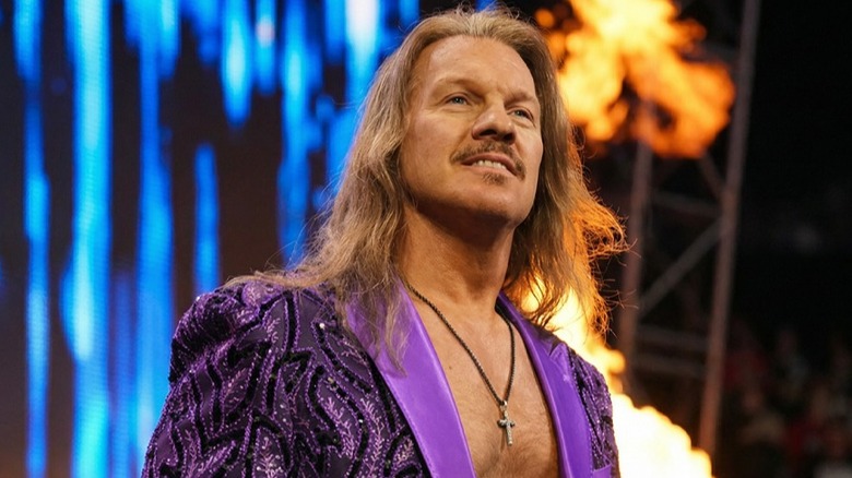 Chris Jericho smiles on before heading towards the ring