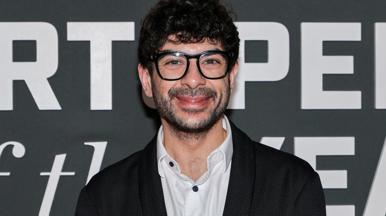 Tony Khan wearing glasses