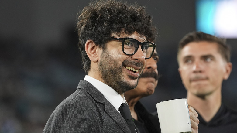 Tony Khan with a coffee mug