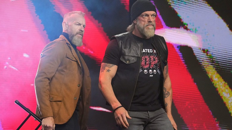 Christian Cage and Adam Copeland making their way to the ring with chairs to attack FTR during an episode of 