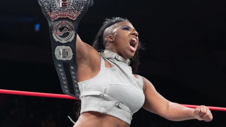 Athena holds up the ROH Women's Title