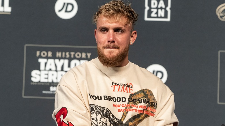 Jake Paul sits at a press conference