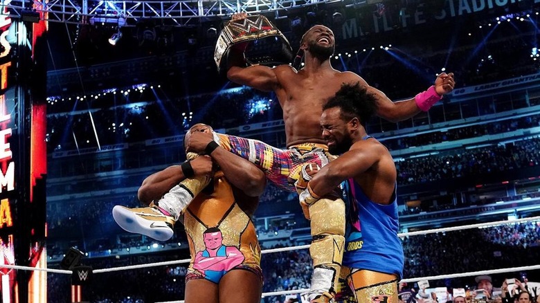 Kofi celebrates with New Day after winning the WWE Championship