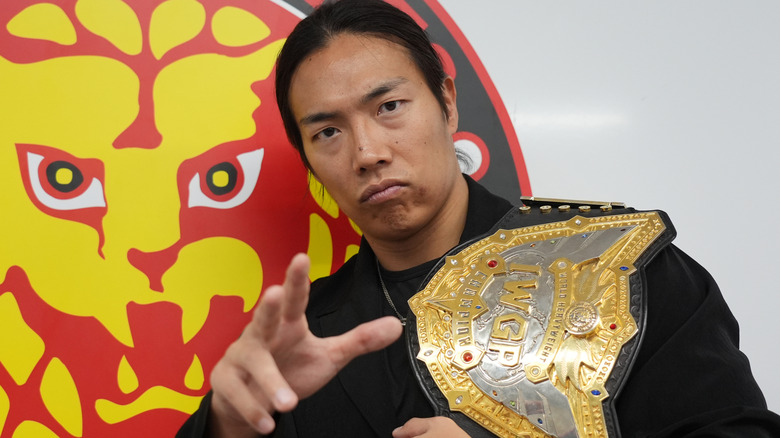Konosuke Takeshita holding the  IWGP World Heavyweight Championship