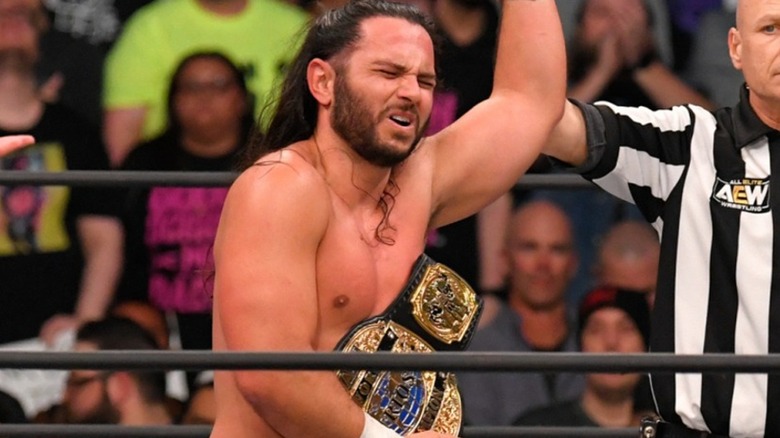 The Young Bucks pose with titles