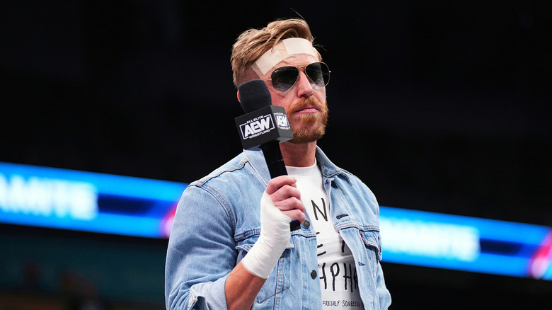 Orange Cassidy holding a mic