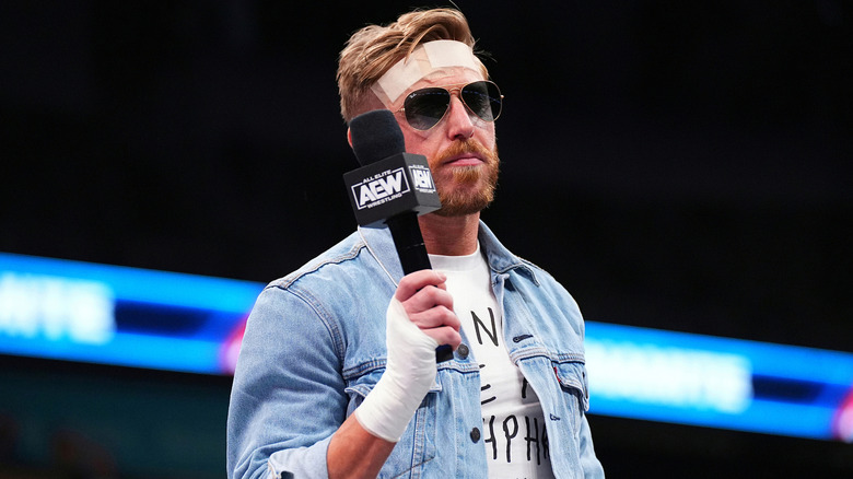 Orange Cassidy holding a microphone