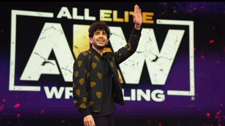 AEW President Tony Khan waves to the crowd during an AEW event