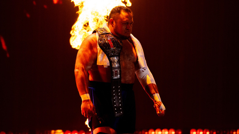 Samoa Joe makes his entrance, with fire behind him