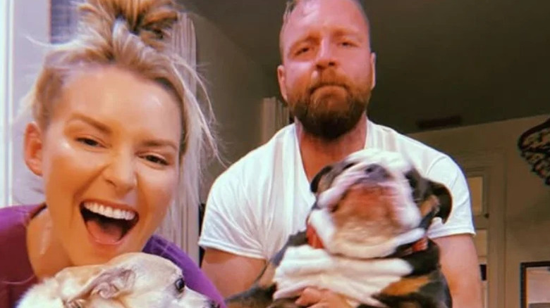 Jon Moxley and Renee Paquette pose with their dogs in their arms in a photo posted to her Instagram account.