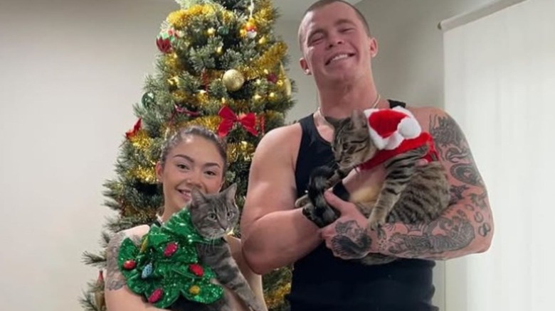 Skye Blue and Kyle Fletcher pose with their cats in front of their Christmas tree in a photo posted to Instagram.