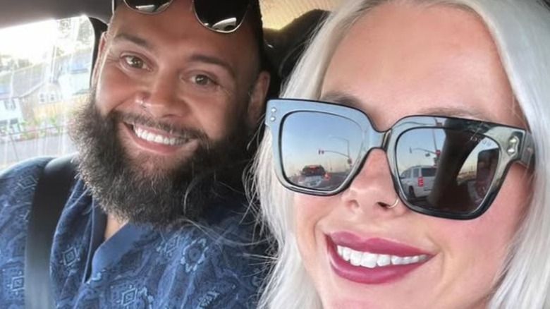 Toa Liona and his wife smile for a selfie in a car in a photo posted to her Instagram.