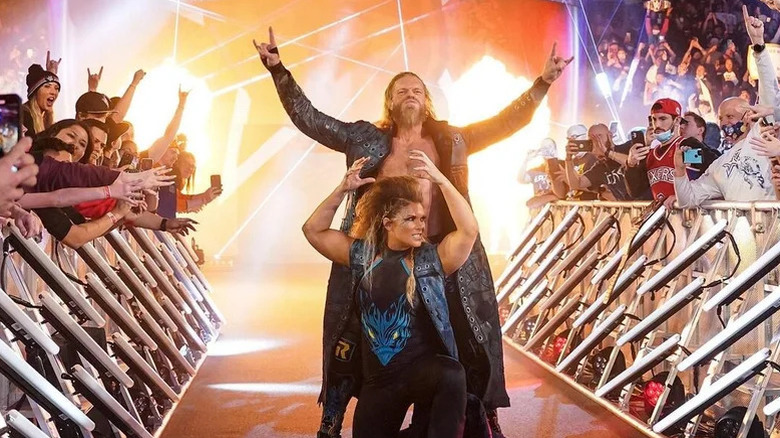 Adam Copeland, then known as Edge, and Beth Phoenix pose on the ramp before a match on WWE programming.