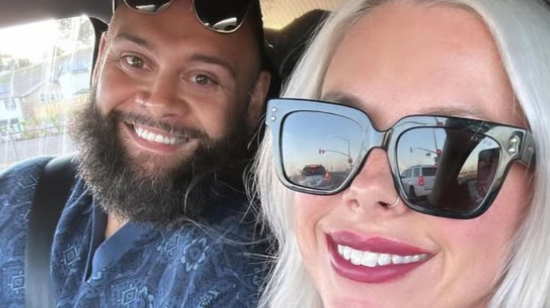 Toa Liona and his wife smile for a selfie in a car in a photo posted to her Instagram.
