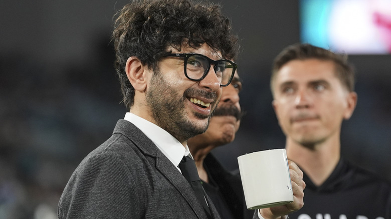 Tony Khan holding a mug