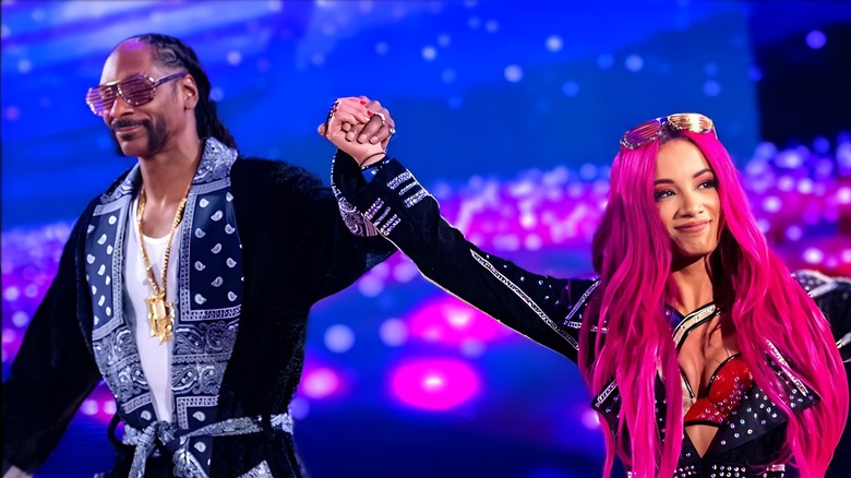 Snoop Dogg escorts Sasha Banks/Mercedes Mone down the ramp