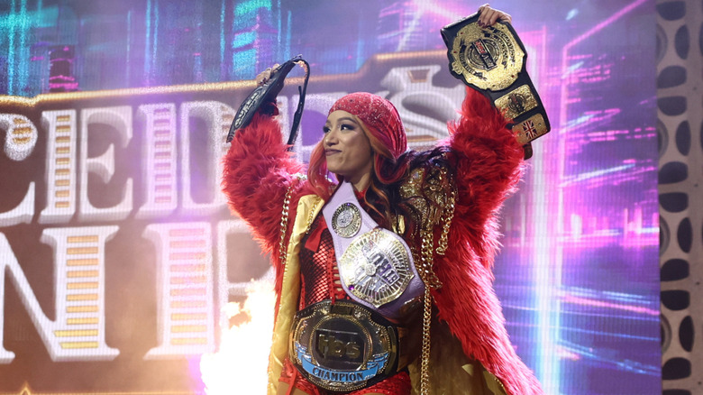 Mercedes Mone walks down the ramp, calling her various belts while wearing the TBS Championship, ahead of a title defense on 