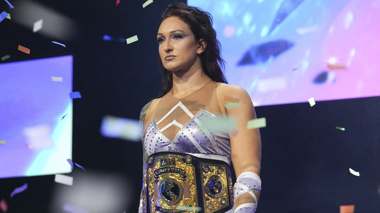 AEW Women's World Champion Kris Statlander heads down to the ring for her match at WrestleDream, confetti flying around her.