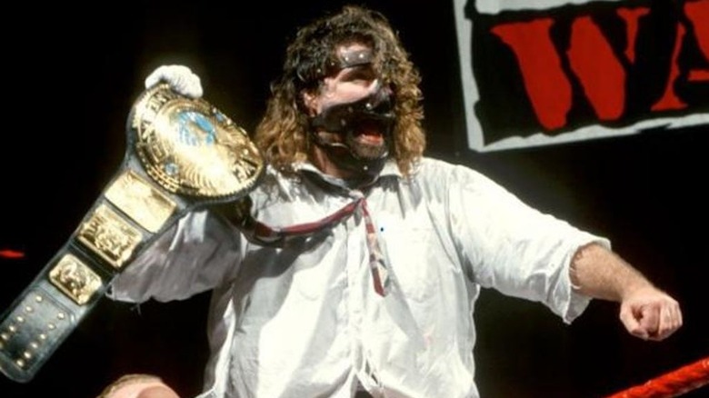 Mankind (aka Mick Foley) celebrates winning the WWE Championship for the first time of three in his career