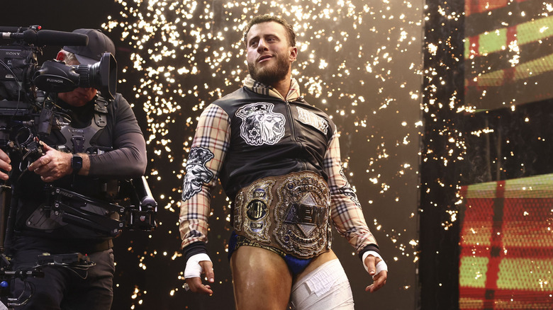 AEW World Champion MJF stands on the stage, flanked by a camera man, during his entrance before a match on the June 17, 2026 edition of 