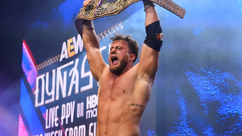 MJF holding the AEW World Championship above his head after successfully defending it against Mike Bailey at 