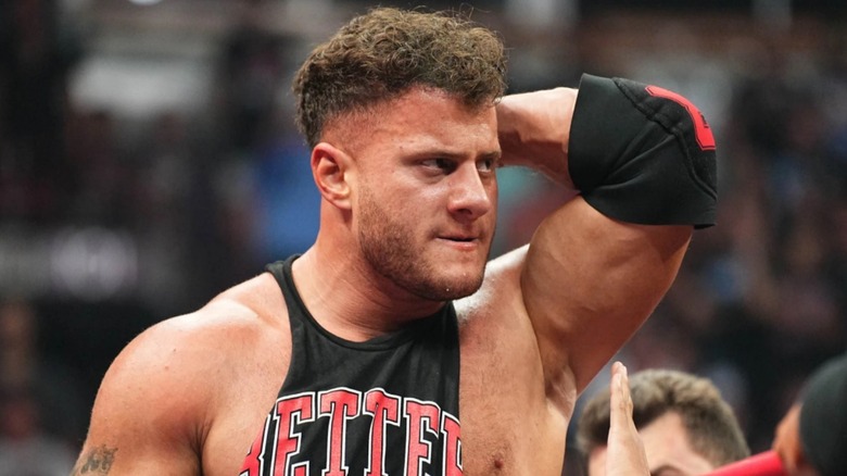 MJF holding his neck, that has been injured because the snake in the grass Adam Cole insists he continue wrestling