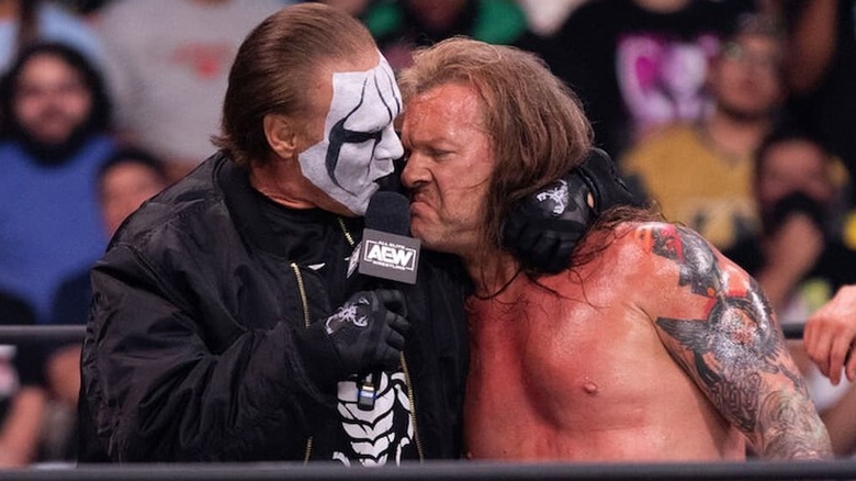 Sting with his arm wrapped around Chris Jericho