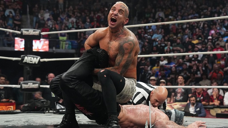 Darby Allin drowns Jon Moxley in a shallow puddle with the Scorpion Deathlock