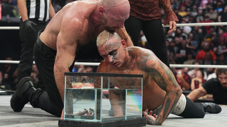 Jon Moxley prepares to drown Darby Allin in a fish tank in the ring at AEW WrestleDream