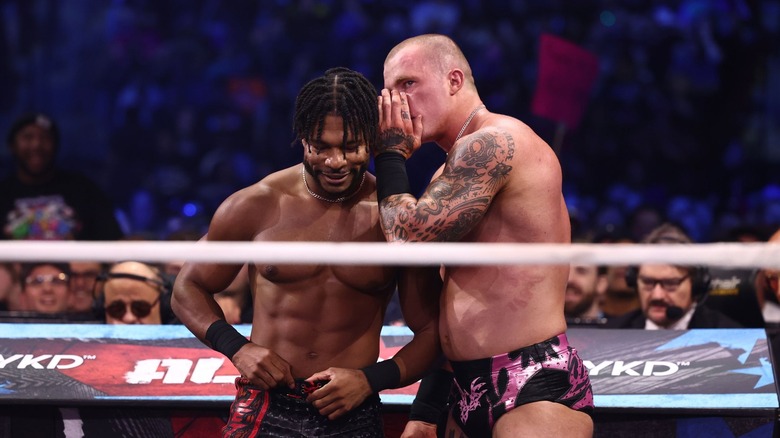 Kyle Fletcher whispers in Kevin Knight's ear