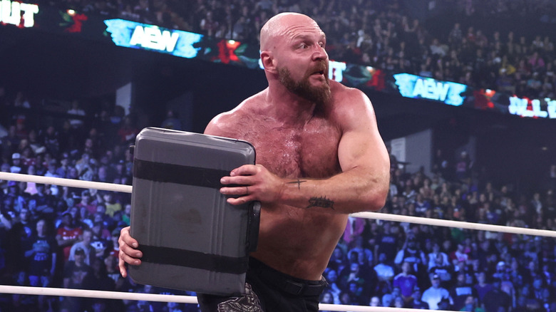 Jon Moxley using a briefcase as a weapon