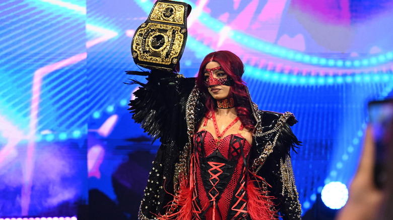 AEW Women's World Champion Mercedes Mone holds up the title during her entrance ahead of a tag team match on the October 14, 2026 edition of "AEW Dynamite."