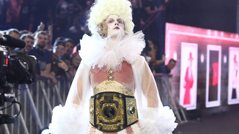 Toni Storm makes her appearance in stark white makeup, a muted pink set of gear, and the AEW Women's World Championship around her waist.