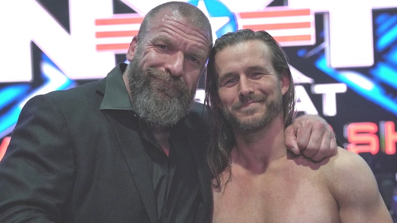 Triple H and Adam Cole embrace