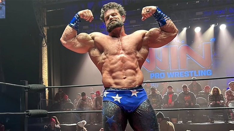 Brian Cage flexing in the ring during a scene for Disclosure Day