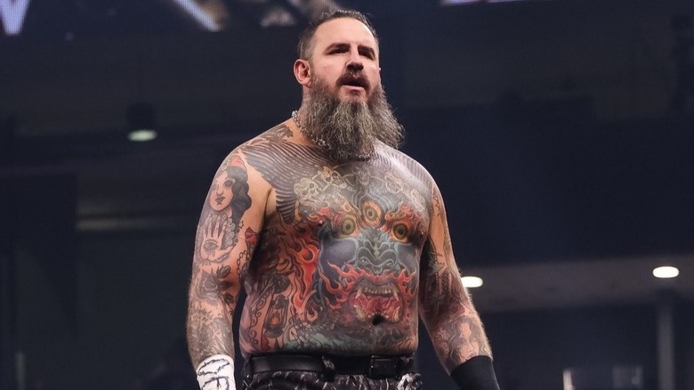 Brody King stands on the wrestling ropes after a victory